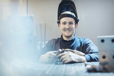 Portrait smiling welder in steel factory - CAIF12555