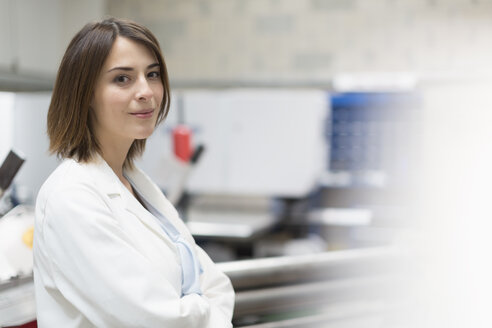 Portrait confident female engineer in steel factory - CAIF12575