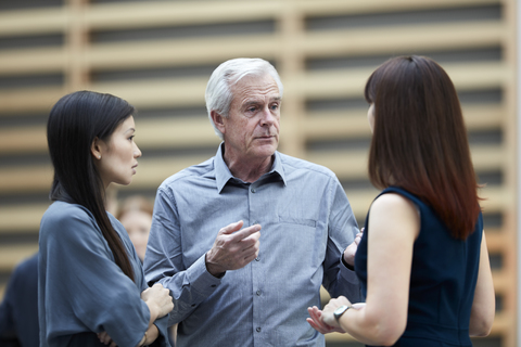 Business people talking in lobby stock photo