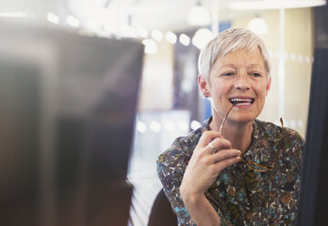 Senior businesswoman working at computer in office - CAIF12855