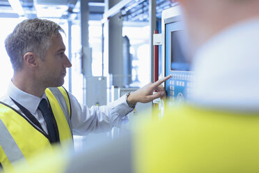 Workers at control panel in factory - CAIF12991