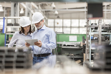 Engineers using digital tablet in steel factory - CAIF13200