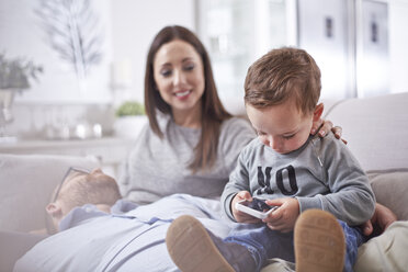 Curious toddler using cell phone - CAIF13219