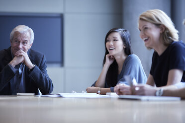Businesswomen laughing in meeting - CAIF13271
