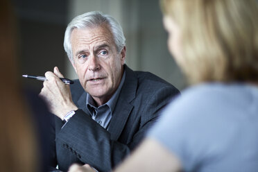 Senior businessman listening to businesswoman in meeting - CAIF13274