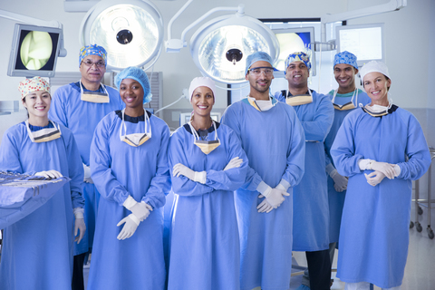 Portrait of confident team of surgeons in operating room stock photo