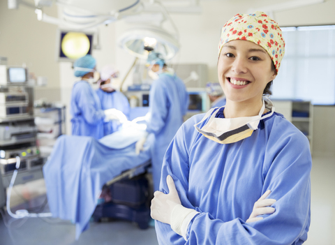 Portrait of smiling surgeon in operating room stock photo