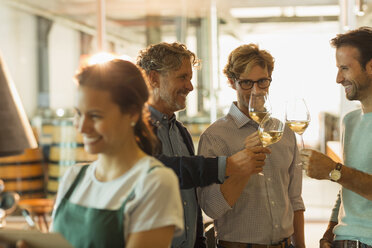 Männer bei der Weinprobe von Weißwein im Verkostungsraum einer Weinkellerei - CAIF13687