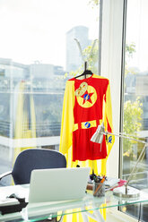 Superhero costume hanging in business office - CAIF13759