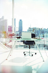 Computer and rolling chair at office desk - CAIF13761