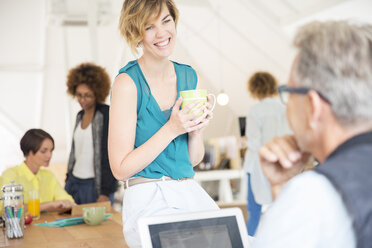 Office workers talking to each other during break - CAIF13781