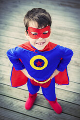 High angle view of superhero boy with hands on hips - CAIF13975