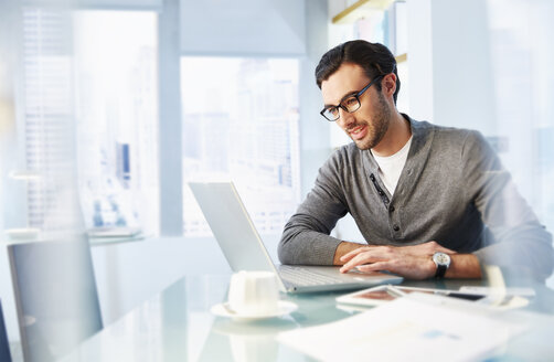 Man working using laptop in office - CAIF14018