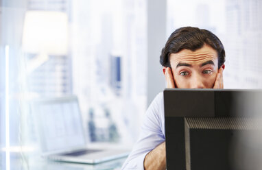 Man using computer in office,stressed and worried - CAIF14024