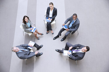 High angle portrait of smiling business people meeting in circle - CAIF14212