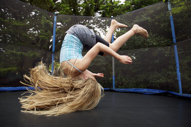 Mädchen springt auf Trampolin im Freien - CAIF14260