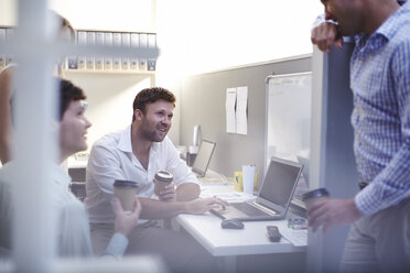 Architekten im Gespräch und beim Kaffeetrinken am Laptop im Büro - CAIF14357