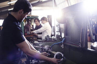 Mechanic working on machinery part in auto repair shop - CAIF14447