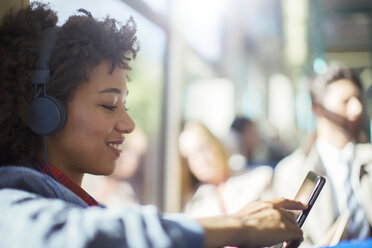 Woman using digital tablet on train - CAIF14572