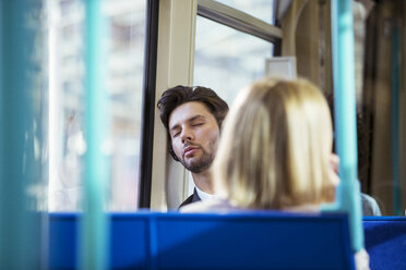 Businessman napping on train - CAIF14579