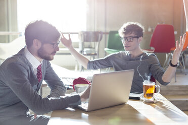 Casual businessmen using laptop in cafe - CAIF14615