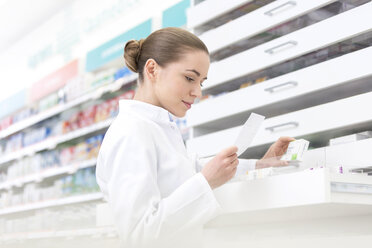 Pharmacist filling prescription in pharmacy - CAIF14679