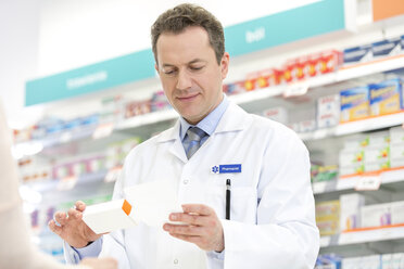 Pharmacist filling prescription in pharmacy - CAIF14683