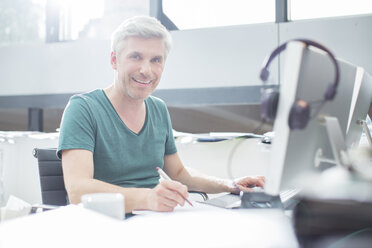 Older man working on computer at desk - CAIF14812