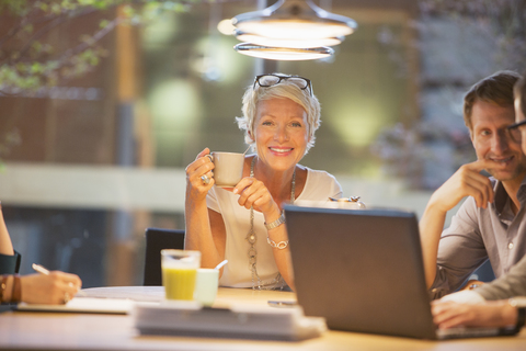 Businesswoman smiling in office meeting stock photo