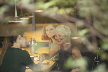 Businesswomen shaking hands in office meeting - CAIF14900