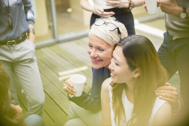 Businesswomen smiling in courtyard - CAIF14910