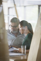 Business people talking at office desk - CAIF14956