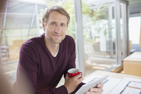 Businessman using digital tablet at office desk stock photo