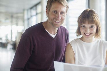 Business people smiling in office - CAIF14962