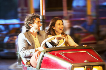 Couple on bumper car ride in amusement park - CAIF15014