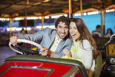 Couple on bumper car ride in amusement park - CAIF15052