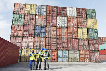 Worker and businessmen talking near cargo containers - CAIF15122