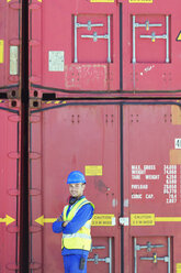 Worker smiling near cargo containers - CAIF15127