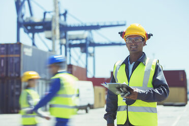 Worker standing near cargo containers - CAIF15142