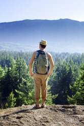 Rear view of man standing on mountain - CAVF06122