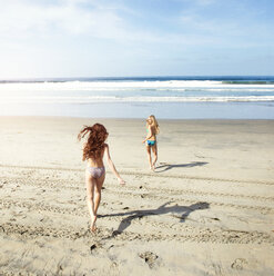 Happy friends in bikini running on shore at beach - CAVF06141