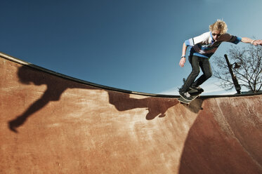 Low angle view of man skateboarding on sports ramp against sky - CAVF06262