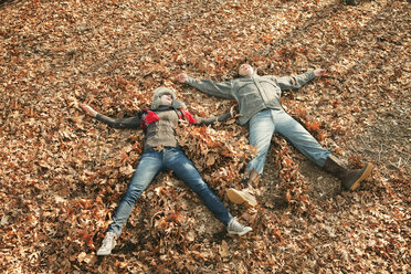 High angle view of couple lying on field - CAVF06364