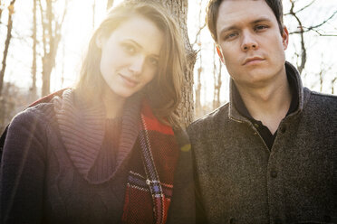 Portrait of couple standing in forest - CAVF06367