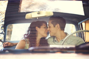 Romantic couple sitting in vintage car - CAVF06443