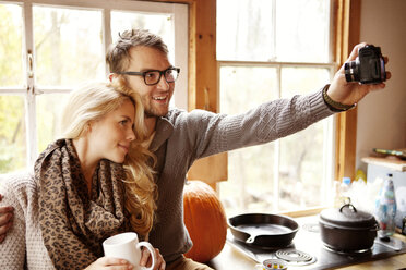 Couple photographing while sitting at home - CAVF06464