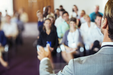 Businessman speaking to audience in conference room - CAIF15255