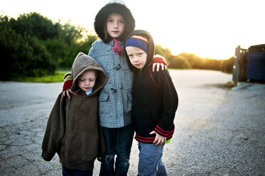 Portrait of siblings standing on road - CAVF06644