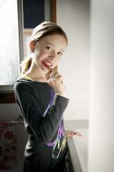 Portrait of girl brushing teeth in bathroom - CAVF06779