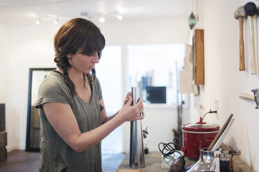 Woman making jewelry in workshop - CAVF06921